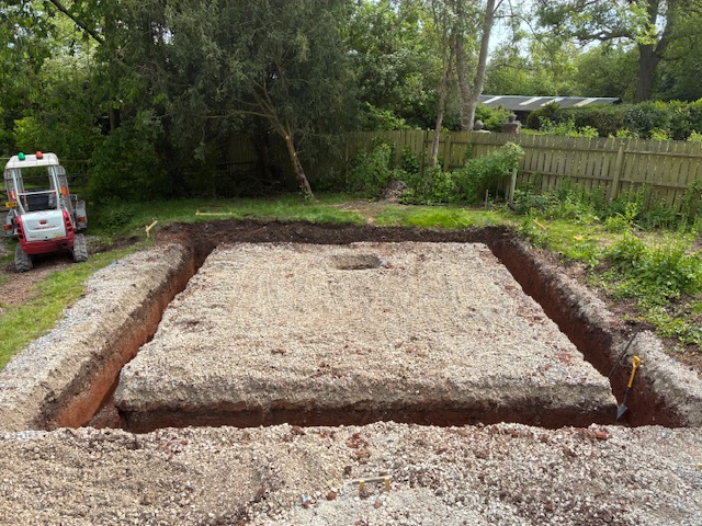 Excavated foundations with compacted stone base ready for concrete