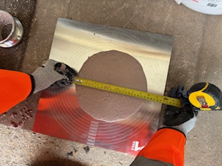 Liquid screed flow consistency test being measured