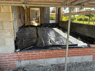 Underfloor heating pipes and tanking membrane laid ready for screed